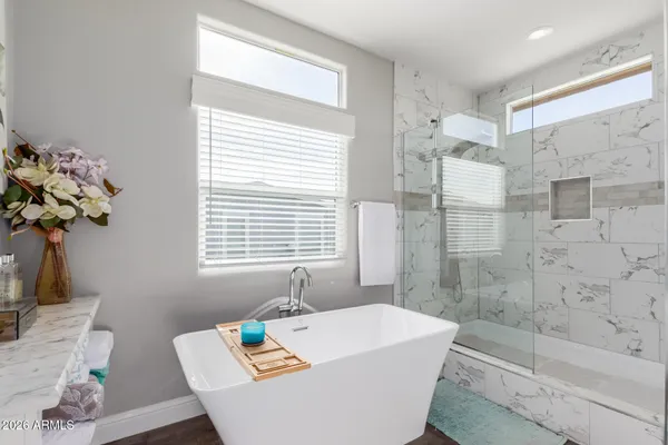 a bath tub sitting in a bathroom next to a window