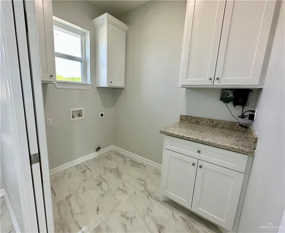 a bathroom with a granite countertop sink and cabinets