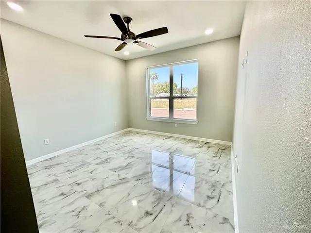 a view of a livingroom with wooden floor and a window