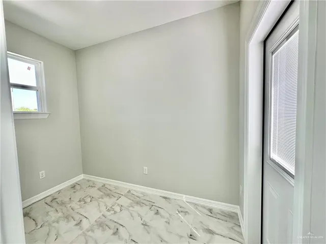 a bathroom with a granite countertop sink a toilet and shower