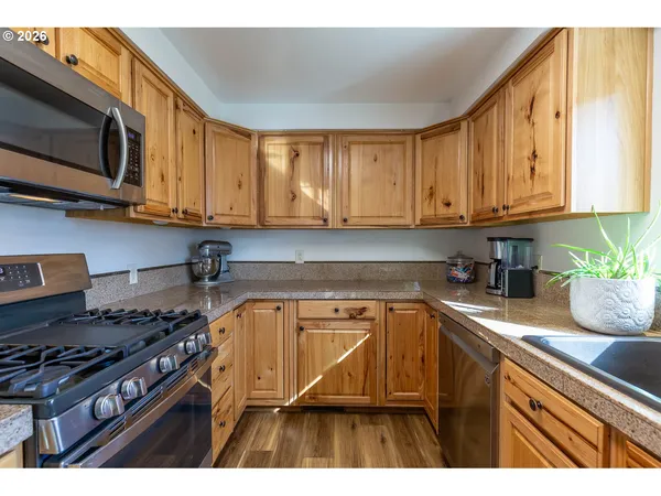 a kitchen with a stove a sink and a microwave