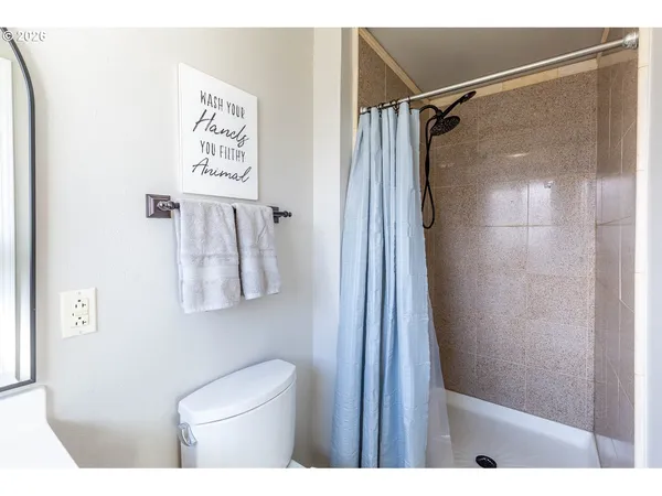 a bathroom with a shower and toilet