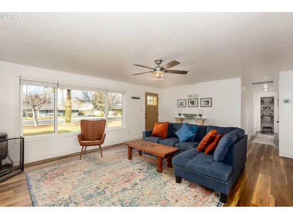 a living room with furniture piano and a window