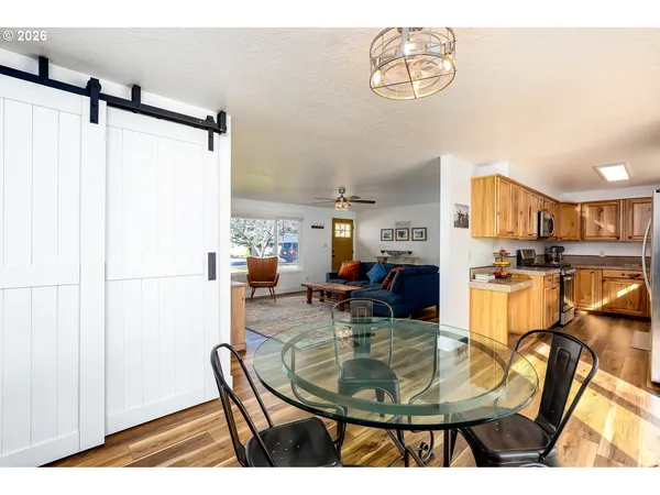 a dining room with kitchen island a table and chairs