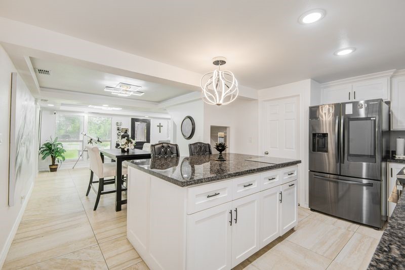 1256 2nd Street Clute, TX 77531 - Photo 16 of 43 a kitchen with kitchen island a counter top space appliances and cabinets
