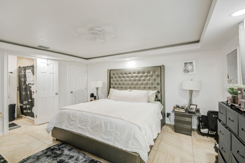 1256 2nd Street Clute, TX 77531 - Photo 17 of 43 a bedroom with a bed and wooden floor