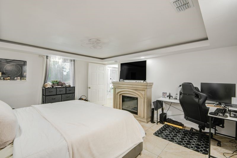 1256 2nd Street Clute, TX 77531 - Photo 20 of 43 a bedroom with a bed and a television