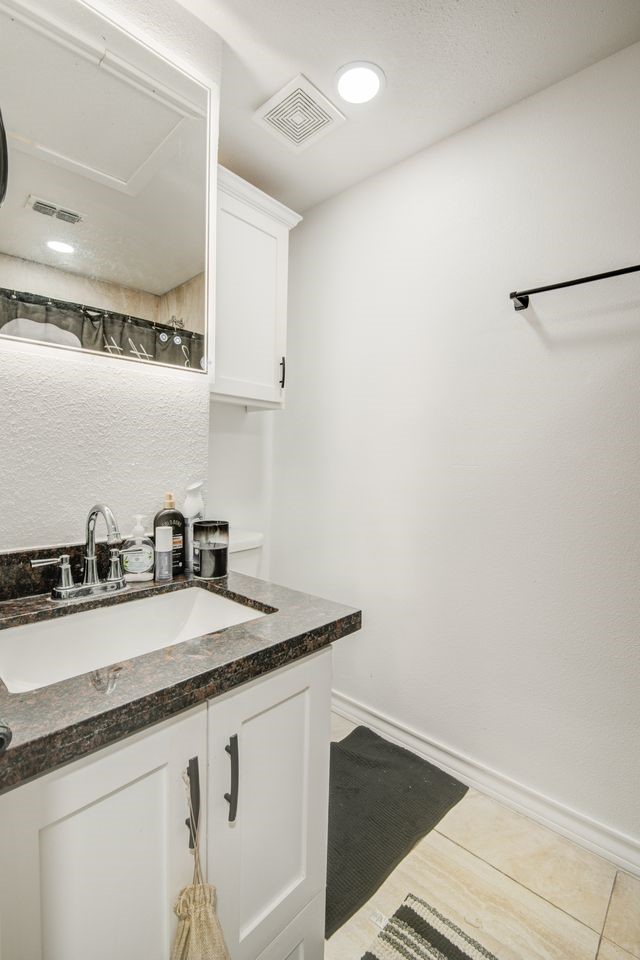 1256 2nd Street Clute, TX 77531 - Photo 21 of 43 a kitchen with granite countertop a sink and a wooden floor