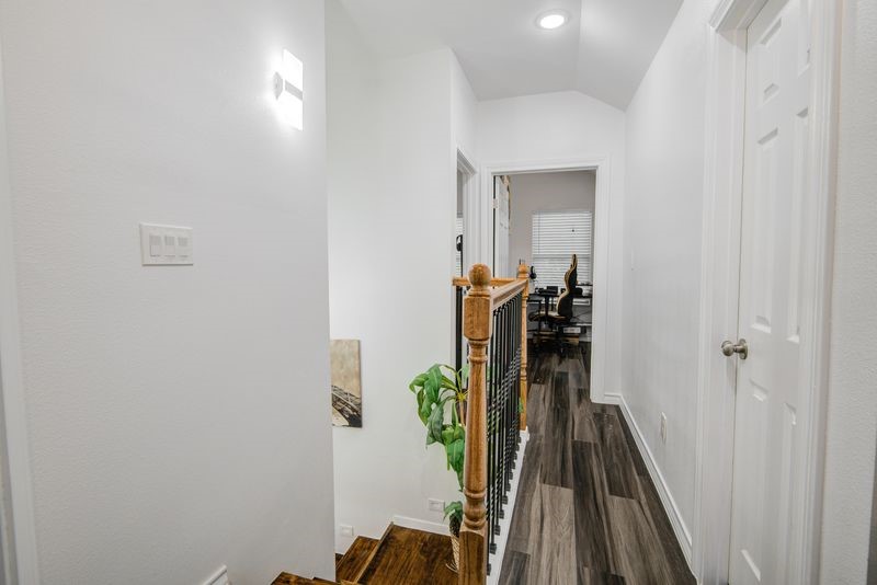 1256 2nd Street Clute, TX 77531 - Photo 26 of 43 a view of a hallway with wooden floor and stairs