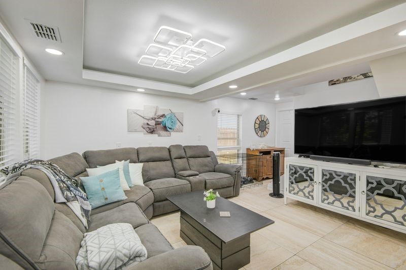 1256 2nd Street Clute, TX 77531 - Photo 8 of 43 a living room with furniture and a flat screen tv