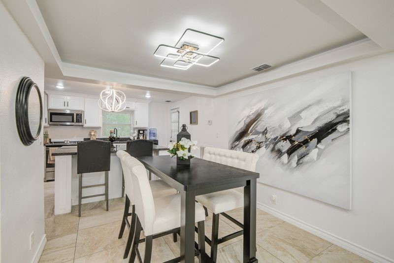 1256 2nd Street Clute, TX 77531 - Photo 9 of 43 a view of a dining room with furniture and a chandelier
