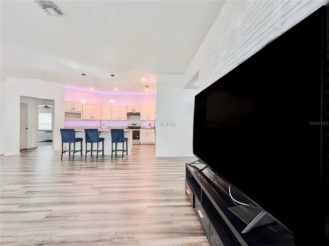 a view of a livingroom with furniture and a flat screen tv
