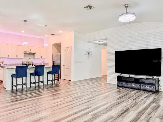 a kitchen with stainless steel appliances granite countertop a sink stove and cabinets