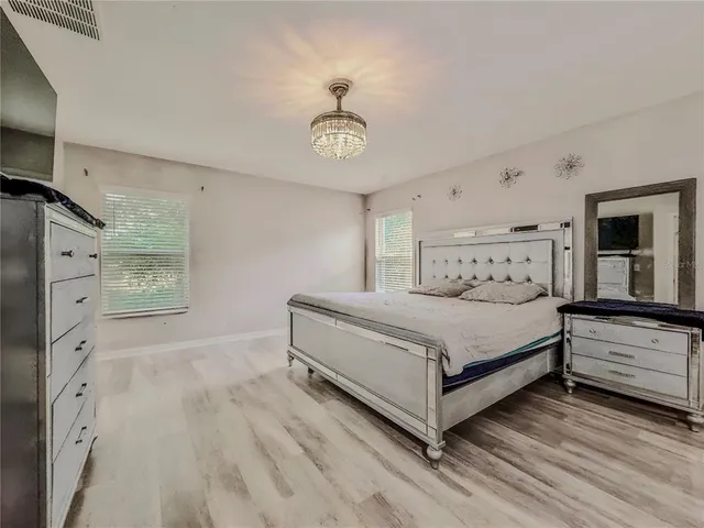 a bathroom with a granite countertop sink mirror and shower