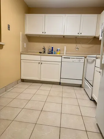 a utility room with cabinets washer and dryer