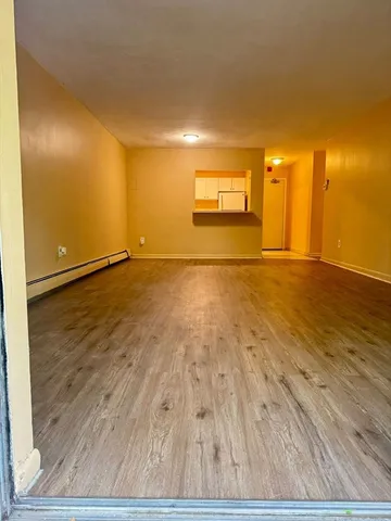 a view of an empty room and wooden floor