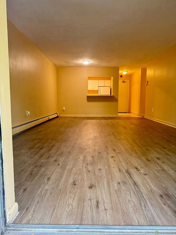 32 Whites Avenue, Unit E112 Watertown, MA 02472 - Photo 2 of 41 a view of an empty room and wooden floor