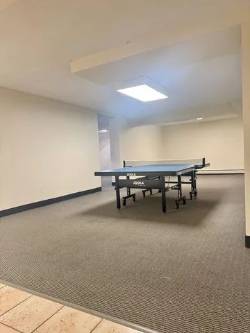 a living room with furniture and a pool table