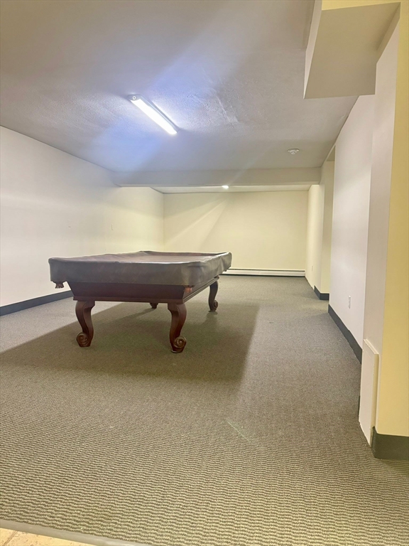 32 Whites Avenue, Unit E112 Watertown, MA 02472 - Photo 37 of 41 a view of an empty room with a wooden floor and a chair
