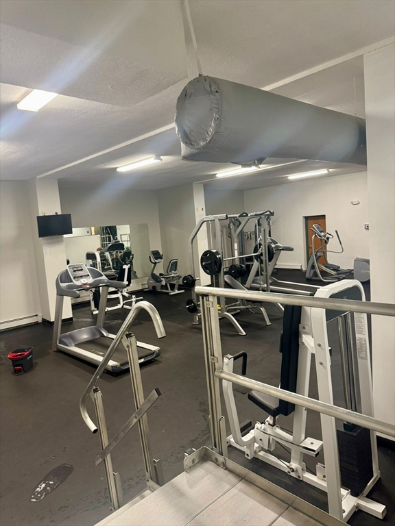 32 Whites Avenue, Unit E112 Watertown, MA 02472 - Photo 39 of 41 a room with gym equipment