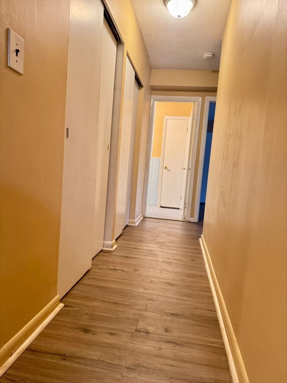 32 Whites Avenue, Unit E112 Watertown, MA 02472 - Photo 5 of 41 a view of a hallway with wooden floor