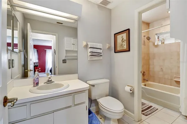 a bedroom with a bed a dresser and flat screen tv