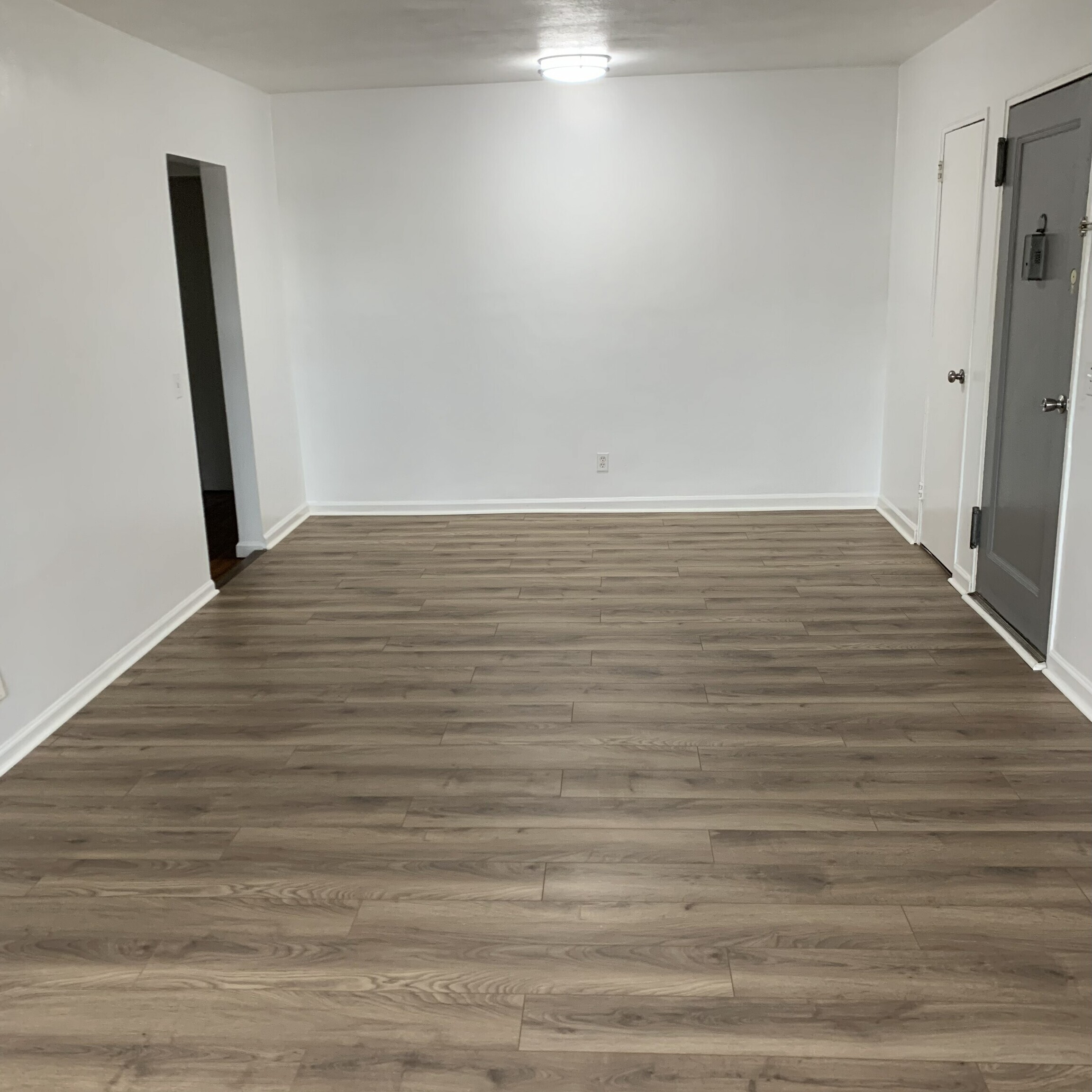 11 Bedford Avenue, Unit J1 Norwalk, CT 06850 - Photo 2 of 10 a view of empty room with wooden floor