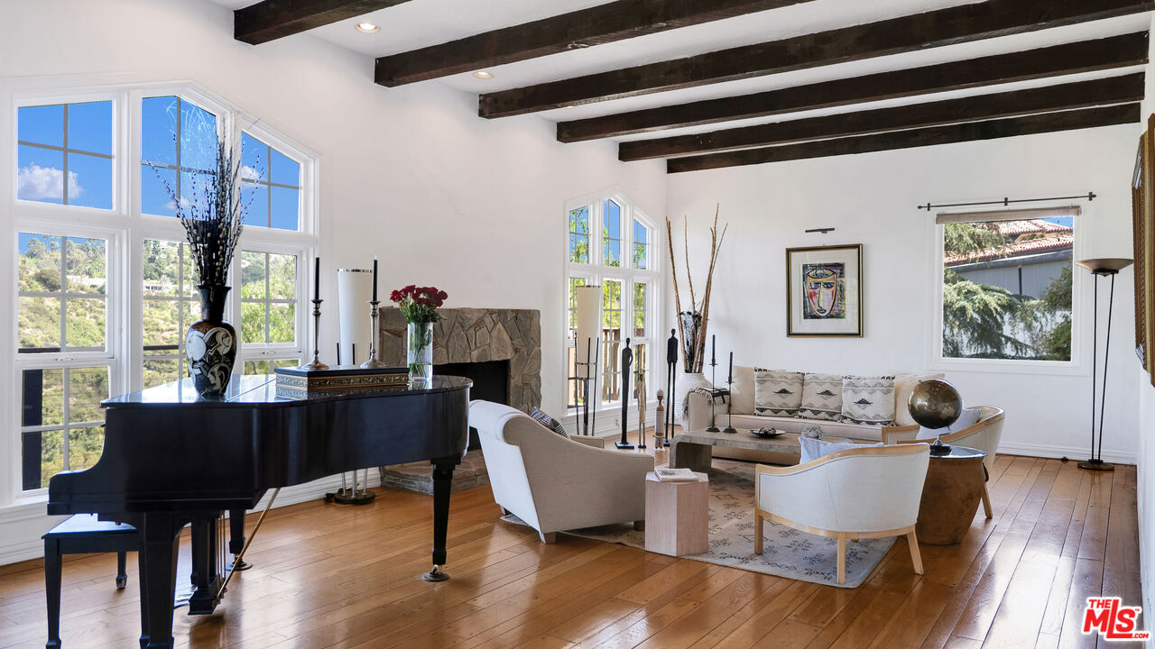 2312 Kimridge Road Beverly Hills, CA 90210 - Photo 53 of 60 a dining room with wooden floor and large windows