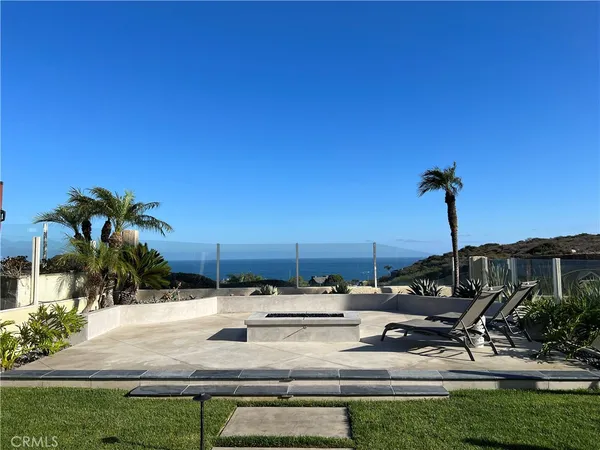 a view of swimming pool with outdoor seating and plants