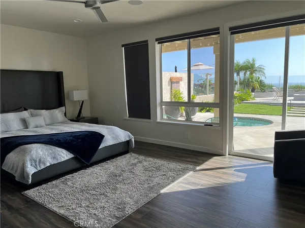 a bedroom with a bed and large window
