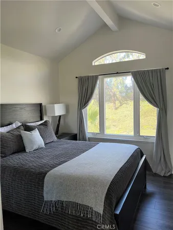 a bedroom with a bed and window