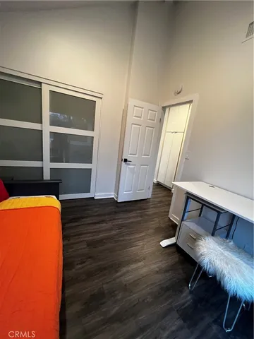 a bedroom with a bed and large window