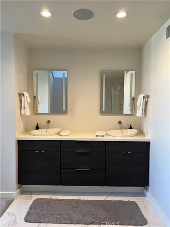 a bathroom with a sink double vanity and a mirror
