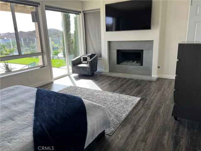 a large bed sitting in a bedroom next to a lamp