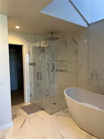 a bathroom with a bathtub and shower
