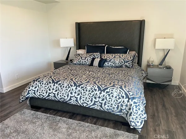 a large bed sitting in a bedroom next to a lamp