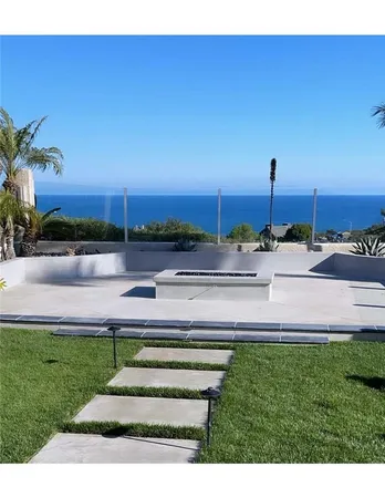 a swimming pool with outdoor seating and yard
