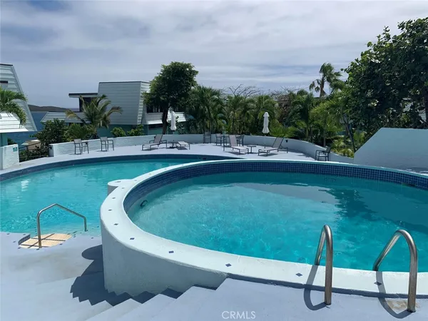 a swimming pool with outdoor seating and yard