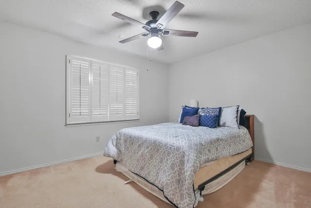 a bedroom with a bed and window