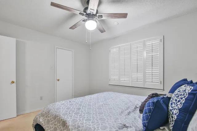 a bedroom with a bed dresser and a window