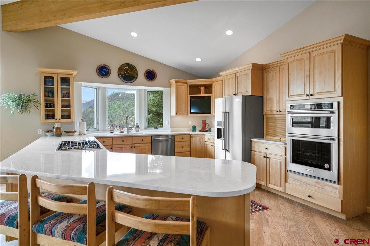 1600 Elk Ridge Trail Ridgway, CO 81432 - Photo 11 of 43 a large kitchen with a table chairs refrigerator and cabinets