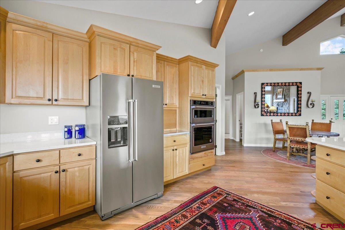 1600 Elk Ridge Trail Ridgway, CO 81432 - Photo 14 of 43 a kitchen with granite countertop a refrigerator and a stove top oven