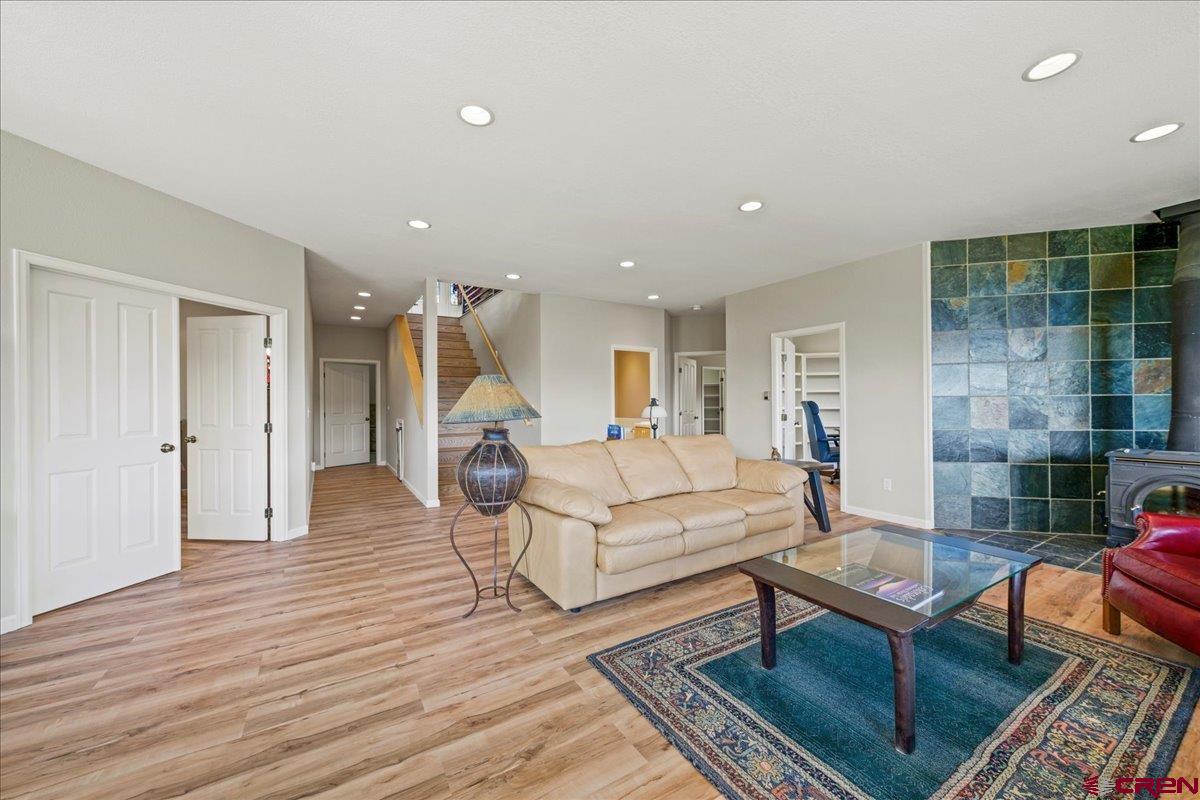 1600 Elk Ridge Trail Ridgway, CO 81432 - Photo 31 of 43 a living room with furniture a rug and a fireplace