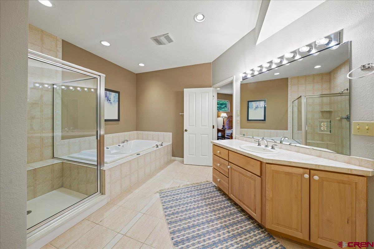 1600 Elk Ridge Trail Ridgway, CO 81432 - Photo 33 of 43 a spacious bathroom with a shower sink mirror and bathtub