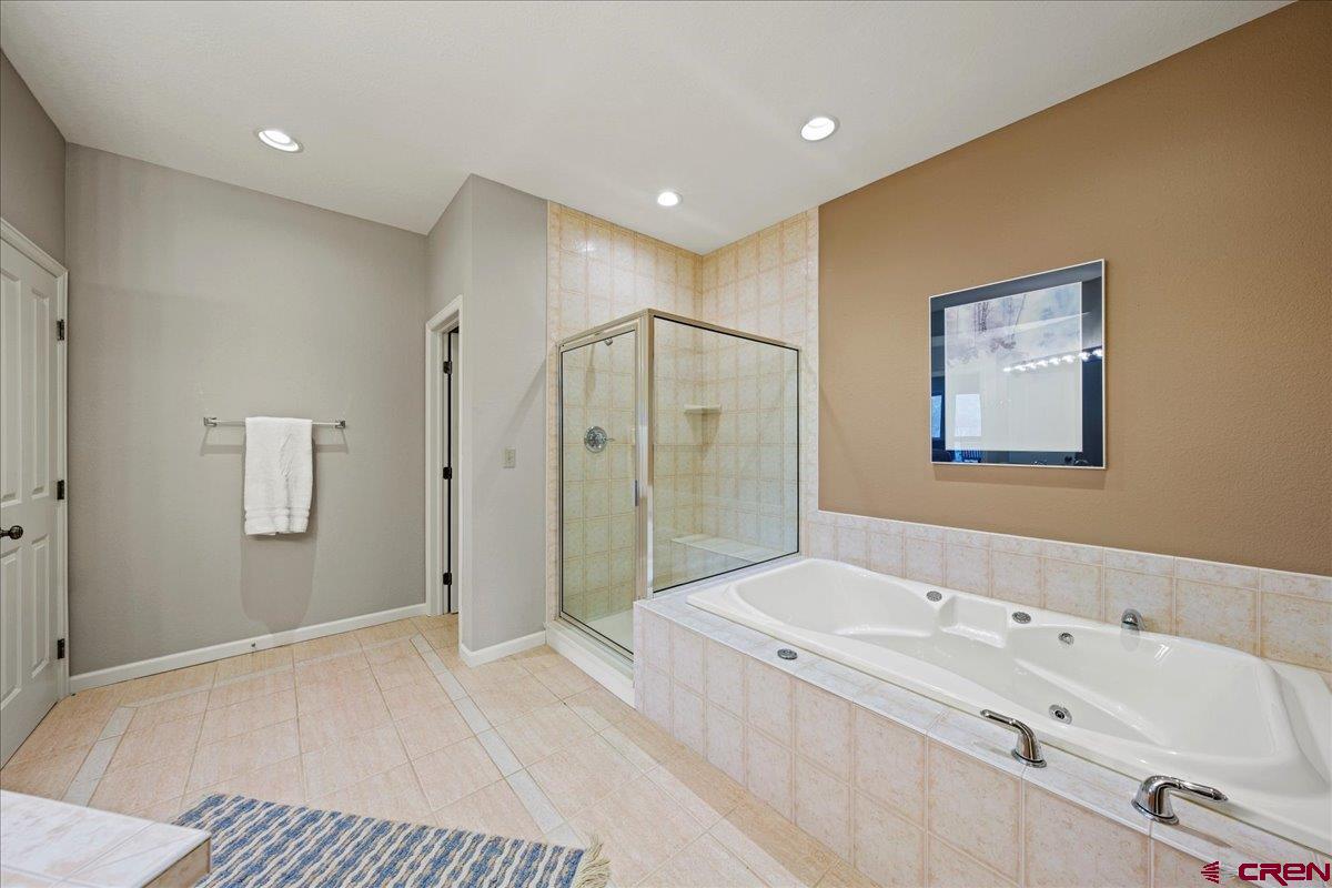 1600 Elk Ridge Trail Ridgway, CO 81432 - Photo 34 of 43 a bathroom with a bathtub and a shower