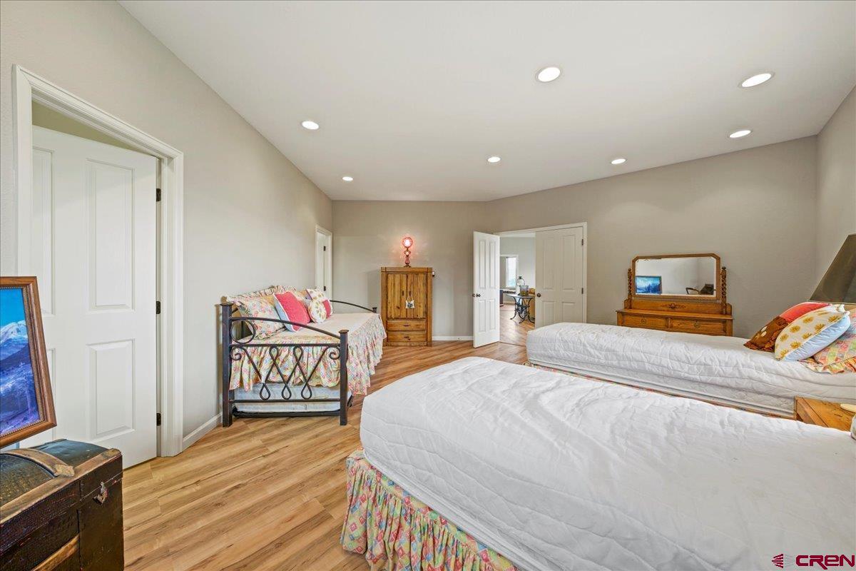 1600 Elk Ridge Trail Ridgway, CO 81432 - Photo 36 of 43 a bedroom with a bed and wooden floor