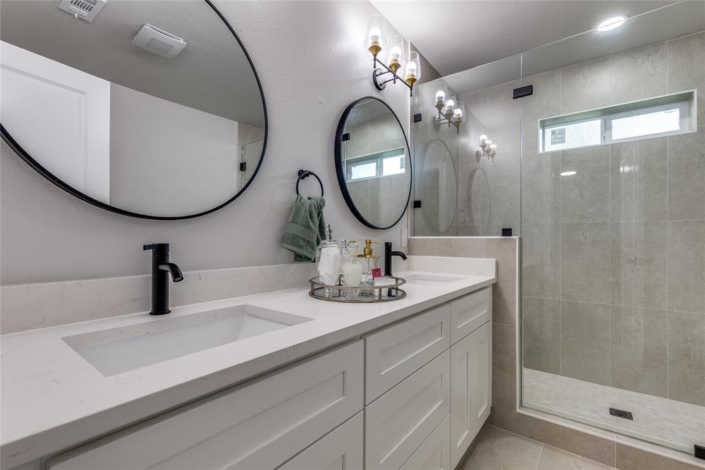 14234 Queens Chapel Road Farmers Branch, TX 75234 - Photo 14 of 21 a bathroom with a sink and a mirror