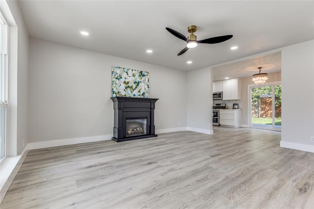 14234 Queens Chapel Road Farmers Branch, TX 75234 - Photo 3 of 21 a view of an empty room with wooden floor and a window