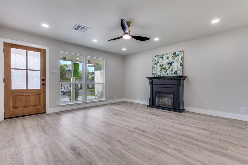 14234 Queens Chapel Road Farmers Branch, TX 75234 - Photo 4 of 21 a view of an empty room with a fireplace and a window