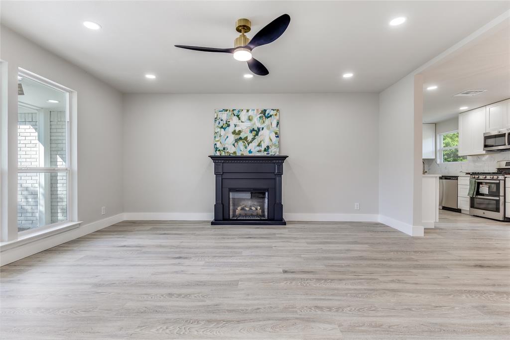 14234 Queens Chapel Road Farmers Branch, TX 75234 - Photo 6 of 21 a living room with furniture and a fireplace